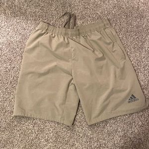 Large tan Adidas shorts.